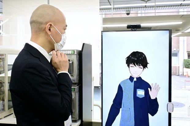 近未来型の「グリーンローソン」で、カメラの前に立つ男性と対話するアバター（奥）＝28日、東京都豊島区（共同）