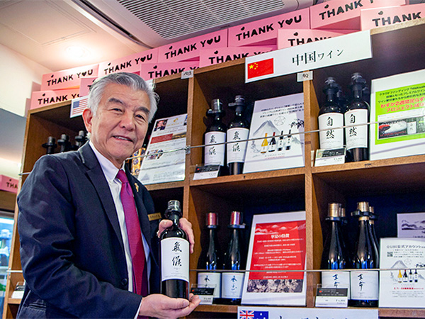 トゥエンティーワンコミュニティは、キャンペーン後も継続して中国産ワインを取り扱う。ワインショップのセラーマスター、江畑進一氏が手に取るのはプレミアム自然派ワイン「ル・シズィエム・エレマン」（同社提供）