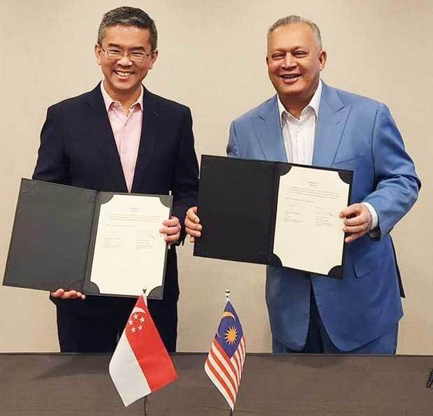 シンガポールとマレーシアの通信当局は越境詐欺対策に共同で取り組む覚書を交わした（情報通信メディア開発庁提供）