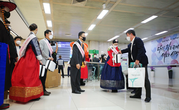 ６月29日に再開された羽田―金浦路線の最初の便で金浦空港に到着した日本からの入国者。伝統衣装を着た韓国側の関係者から歓迎を受けている＝韓国、2022年６月29日（ＮＮＡ撮影）